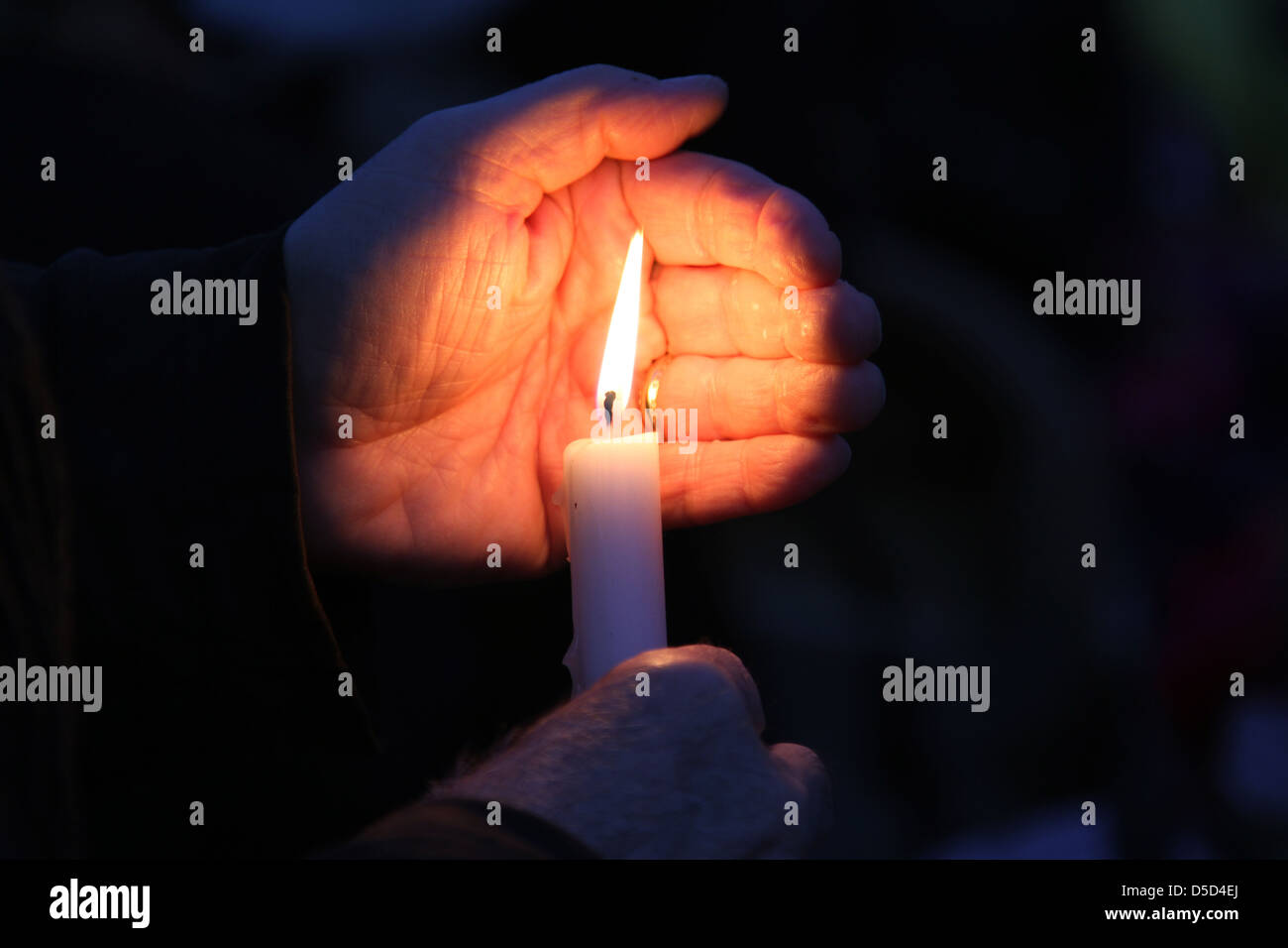 Berlin, Germany, hand protects a candle flame from the wind Stock Photo