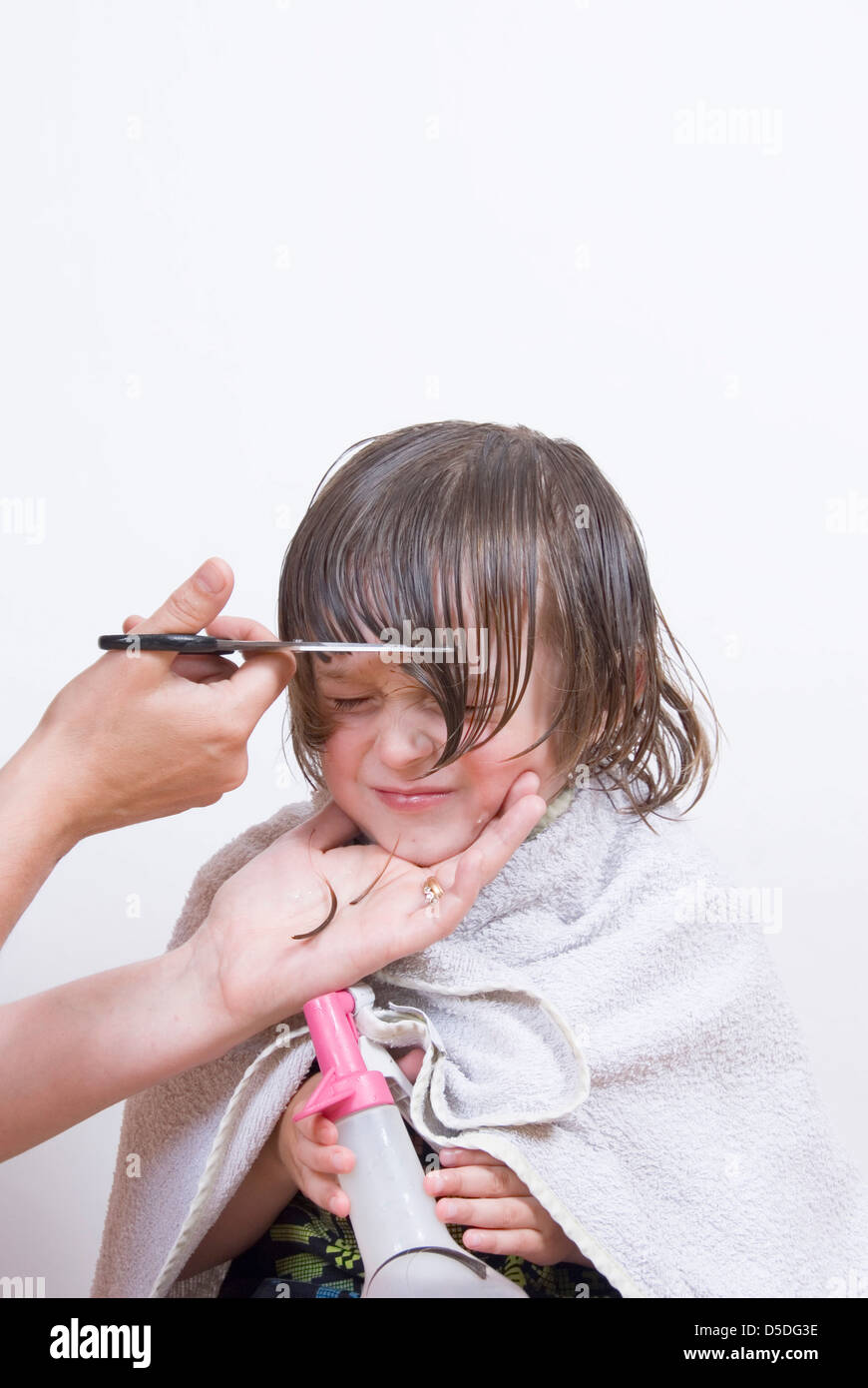 Mom Makes a Haircut for Her Two Year Old Son with Scissors in the Bathroom  at Home Stock Image - Image of casual, scissors: 182291571
