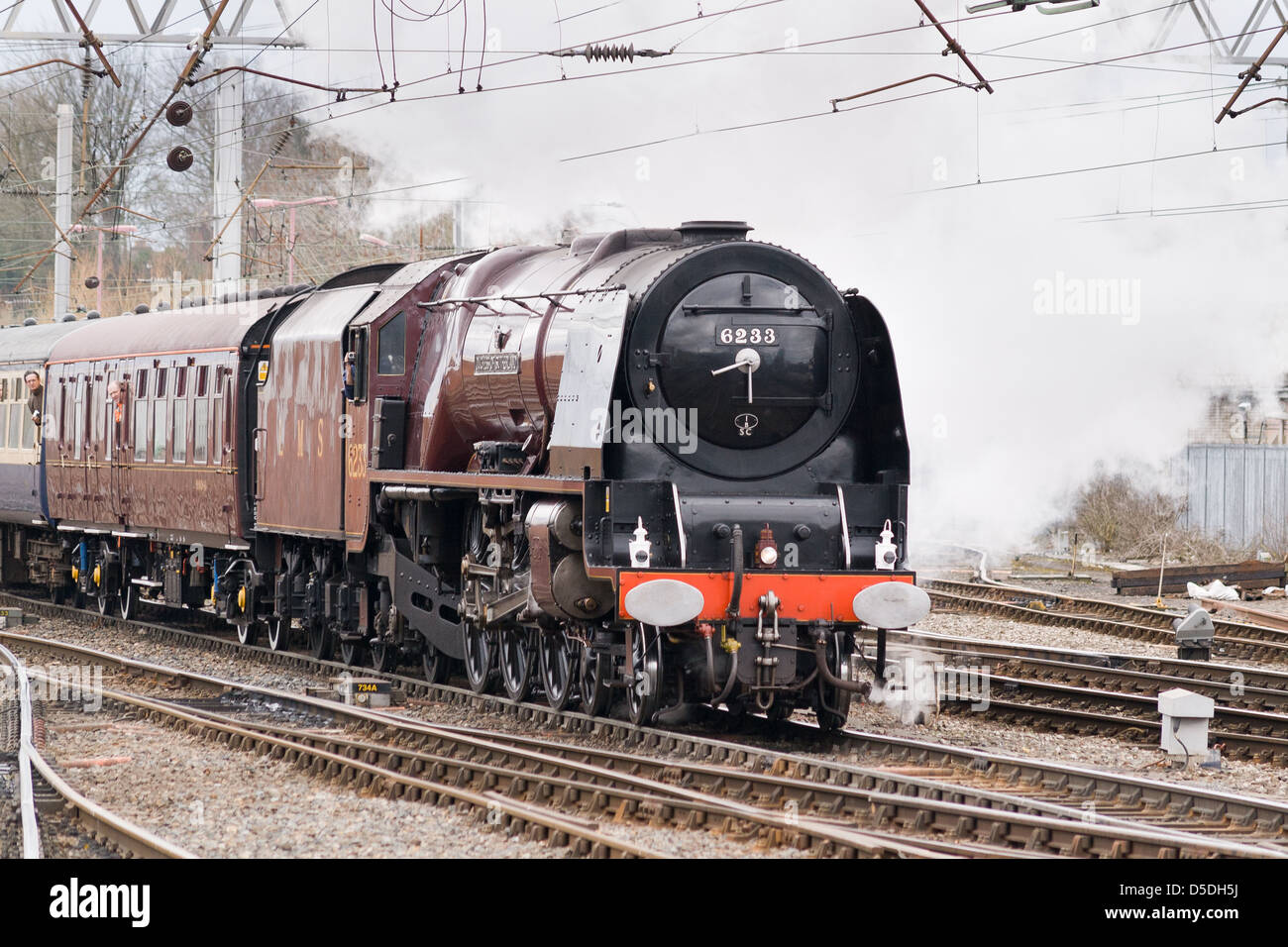 A steam locomotive pulling a passenger train on the main line near Carlisle, England Stock Photo