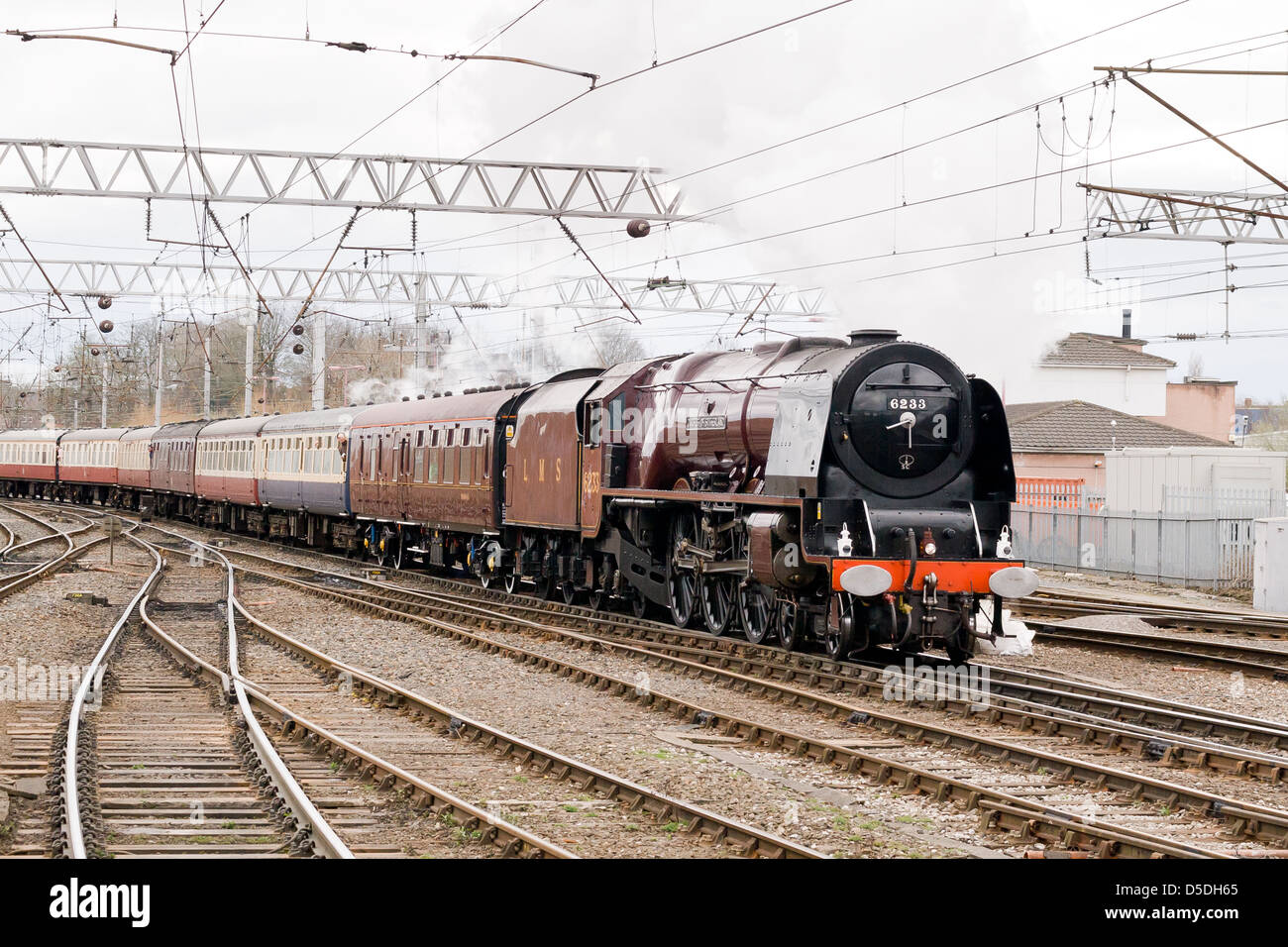 A steam locomotive pulling a passenger train on the main line near Carlisle, England Stock Photo