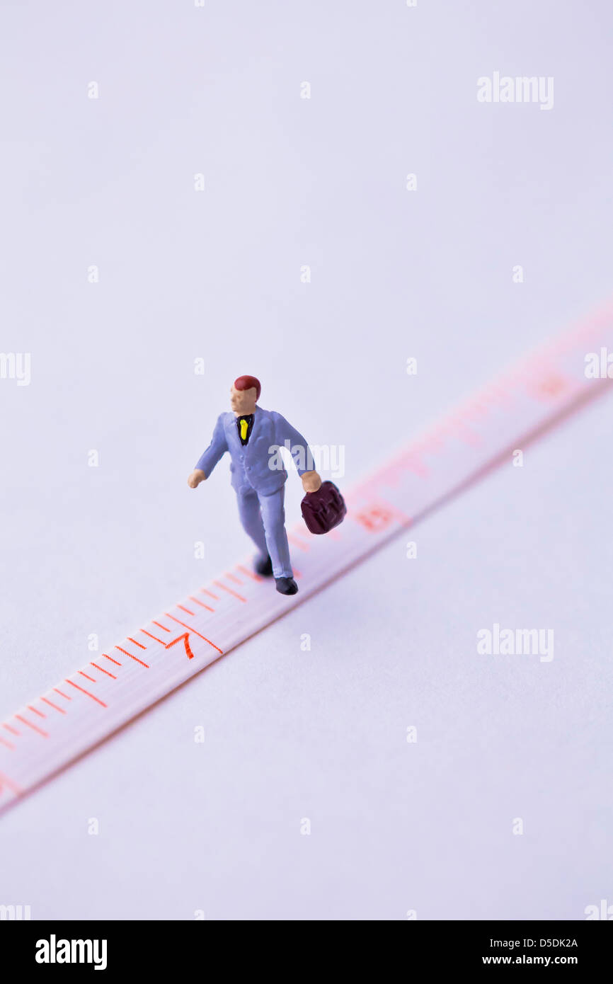 businessman on ruler Stock Photo - Alamy