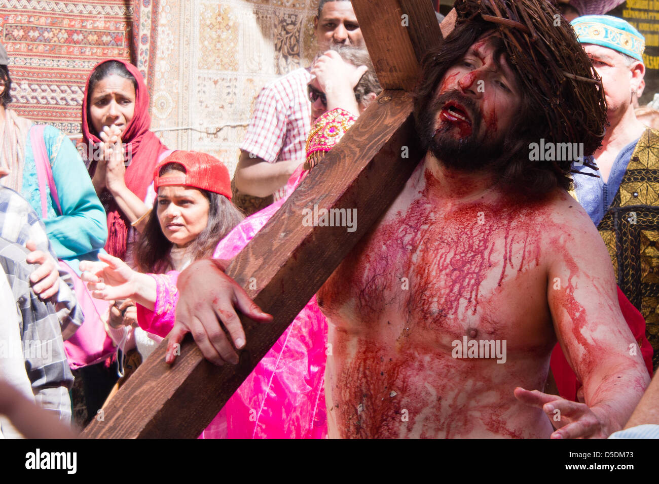 Jerusalem, Israel. 29th March 2013.  Actors reenact the sentencing and crucifixion of Jesus along the Via Dolorosa in a Good Friday procession to the Church of The Holy Sepulchre.  Jerusalem, Israel. 29-Mar-2013.  Thousands of Christian pilgrims retraced the last steps of Jesus through the Via Dolorosa to the Church of the Holy Sepulchre on Good Friday, singing and chanting in a mix of languages, costumes and traditions. Credit: Nir Alon / Alamy Live News Stock Photo