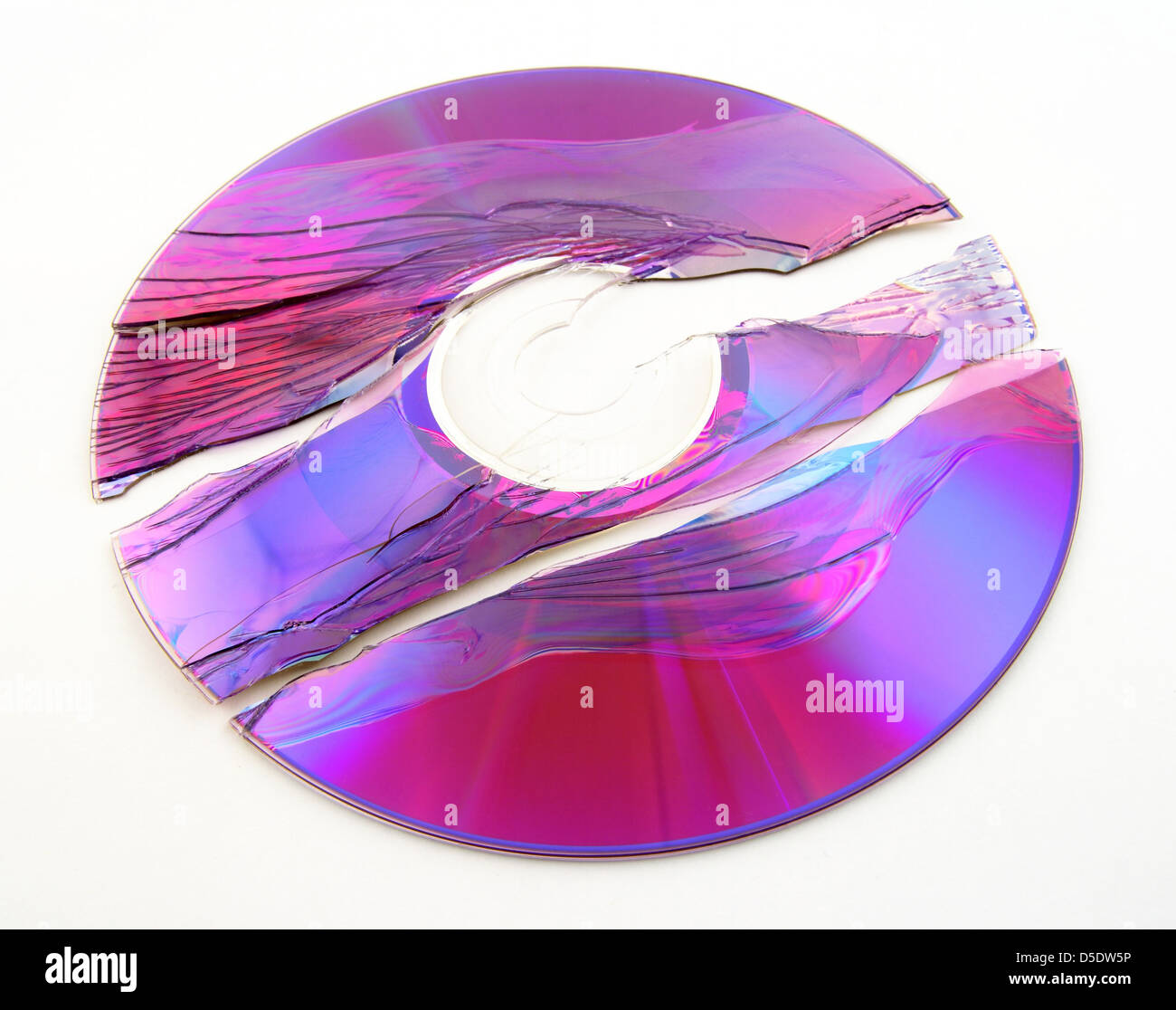 Scratched and broken purple DVD or CD. Stock Photo