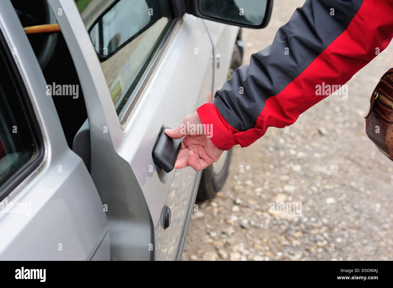A womans hand opening shutting a car door (model released) Stock Photo