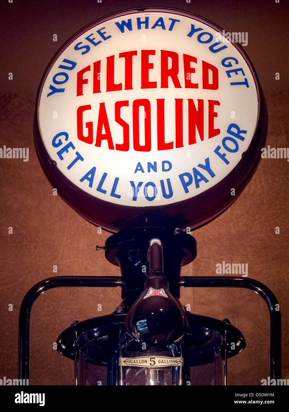 An illuminated advertising sign on a 1935 Bennett 150 service station gasoline pump promises a fair deal for customers. Stock Photo