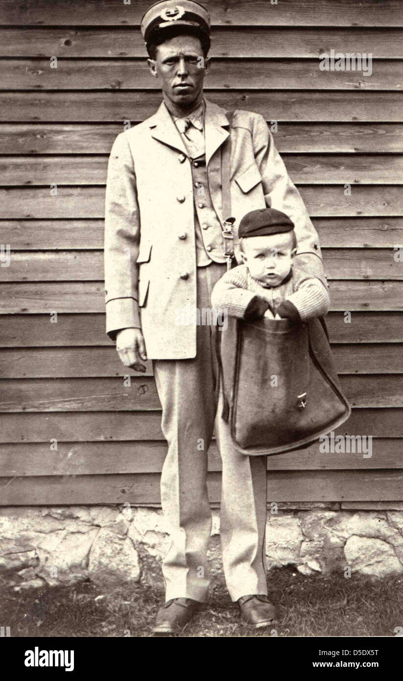 Uniformed Letter Carrier with Child in Mailbag Stock Photo