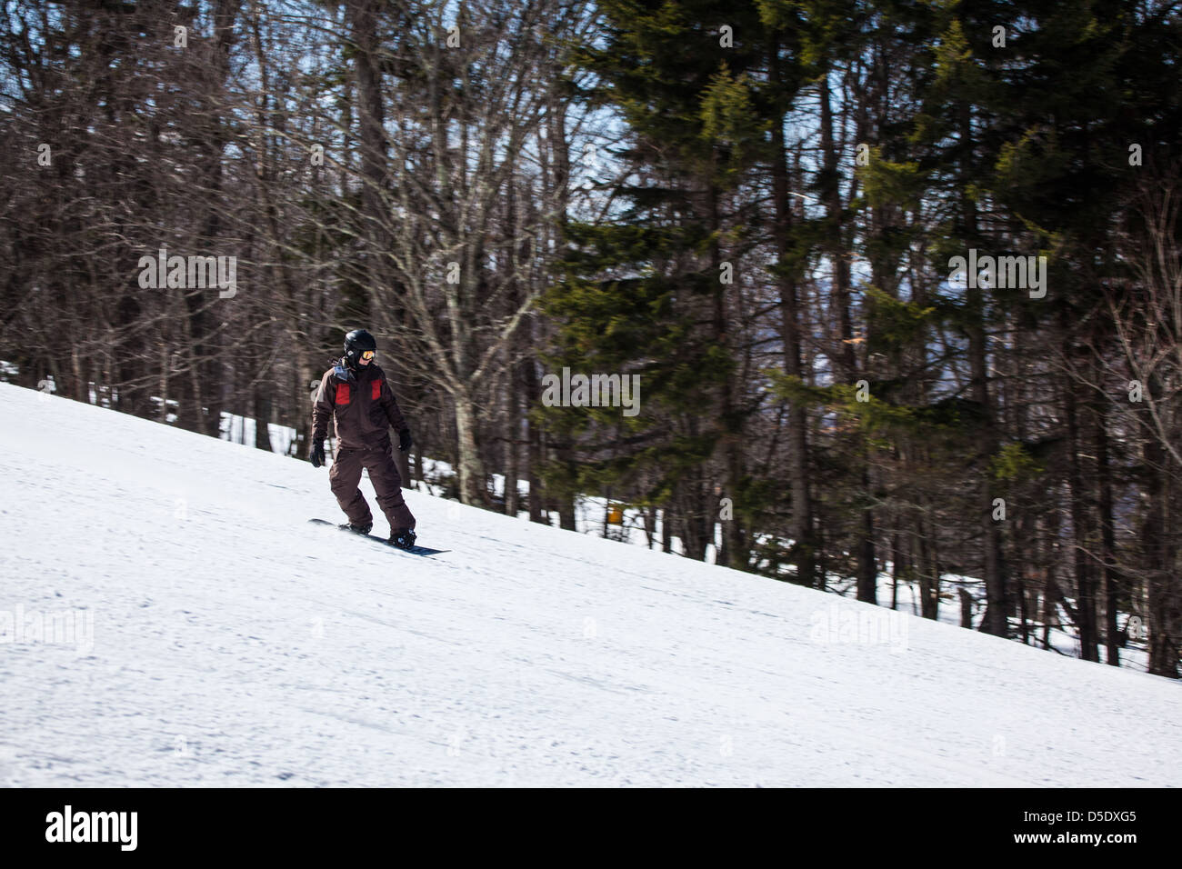 A snowboarder rides down the slopes of Snowshoe Mountain, WV. Stock Photo
