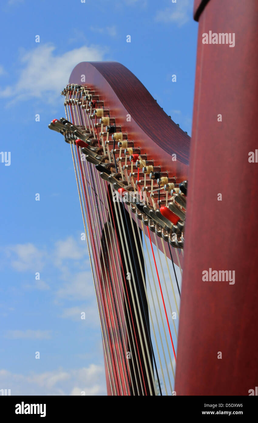 Celtic harp closeup and cloudy sky background - musical instrument Stock Photo