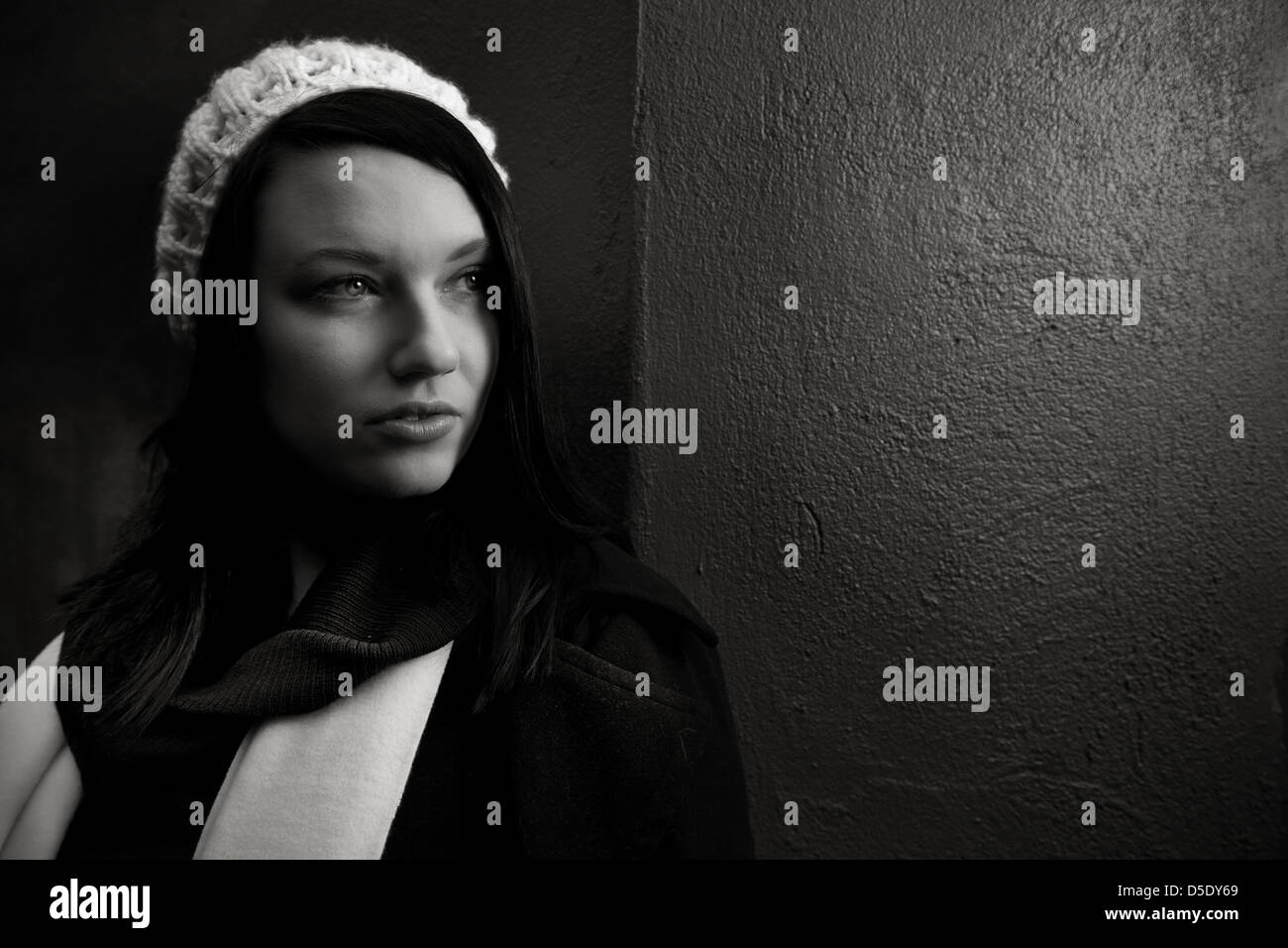 Woman Looking Out Of Dark Corner Into Light Stock Photo Alamy