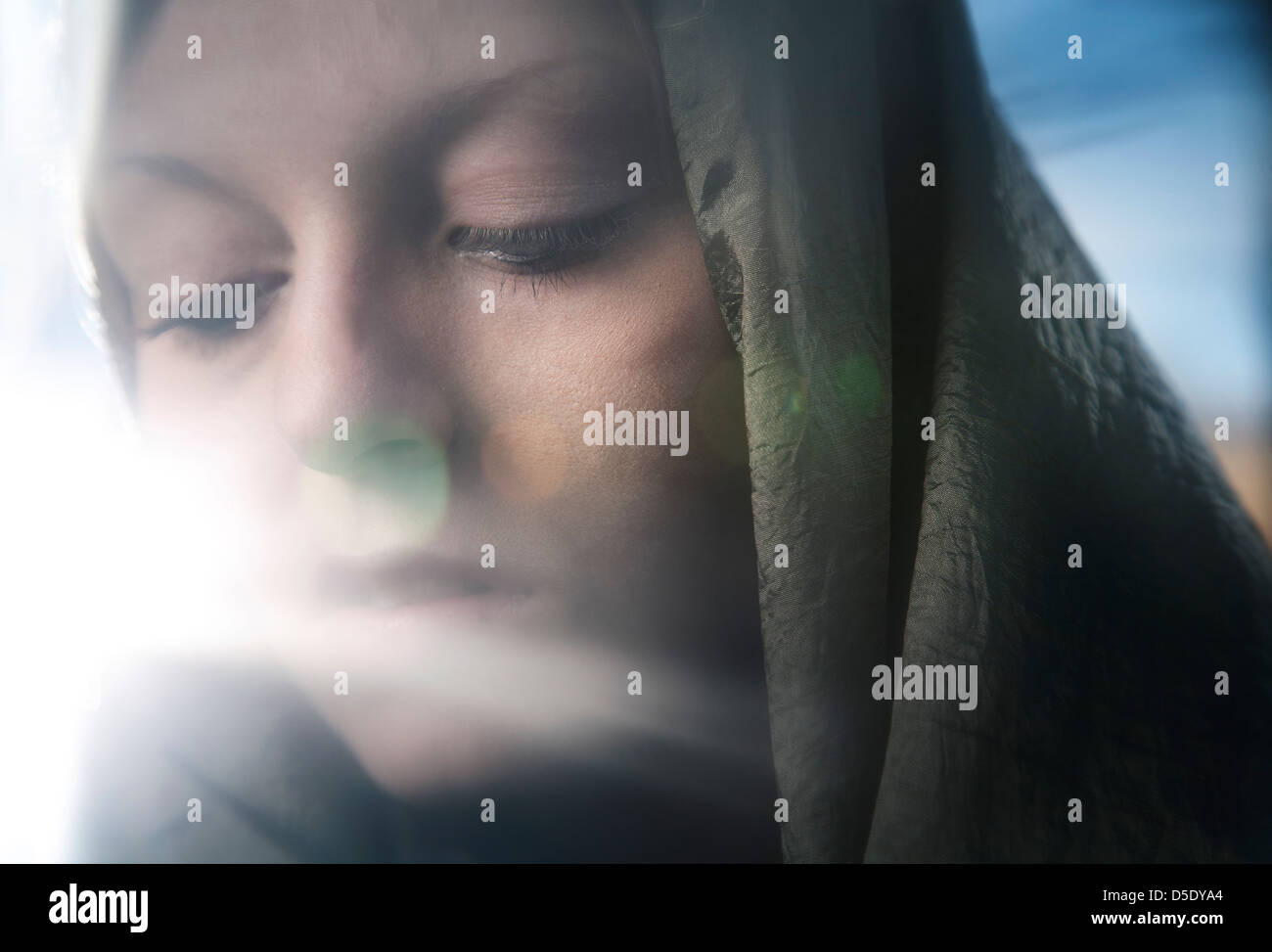Woman wearing scarf with sun flair Stock Photo