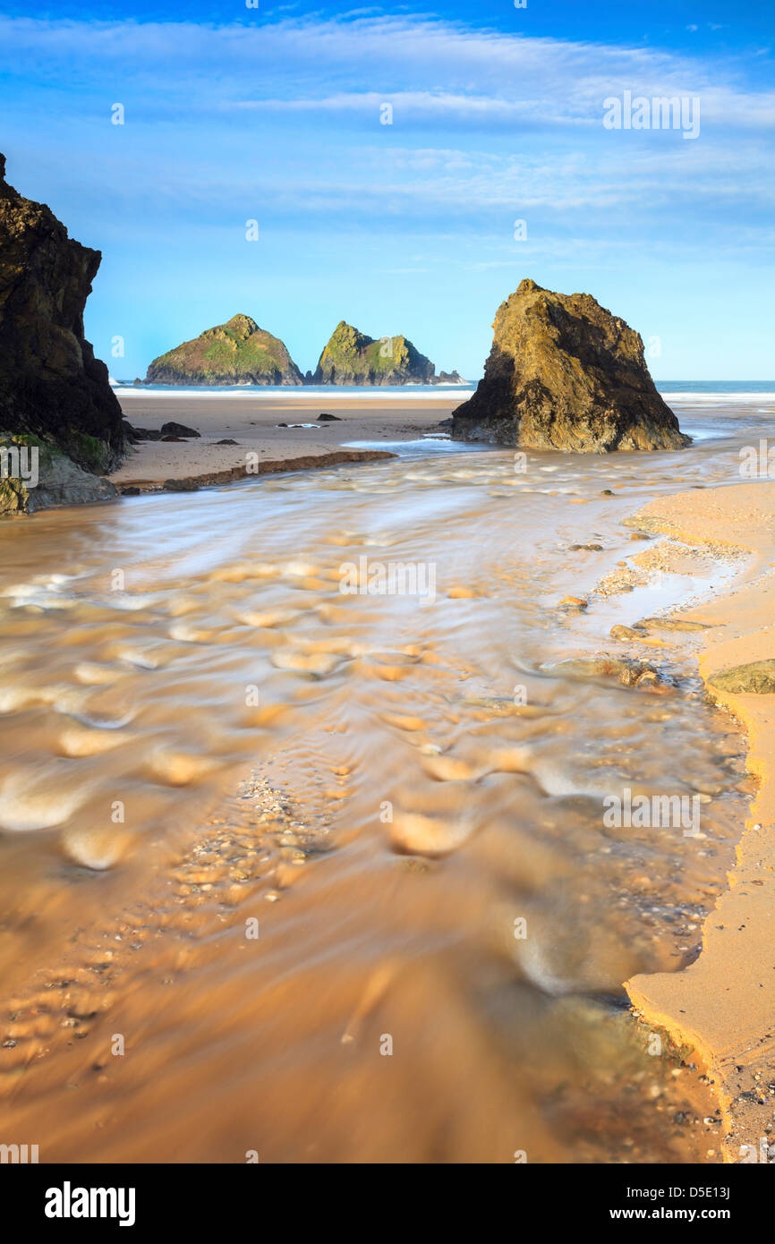 The river on Holwell Bay beach in Cornwall, captured using a long shutter speed to blur the movement in the water. Stock Photo
