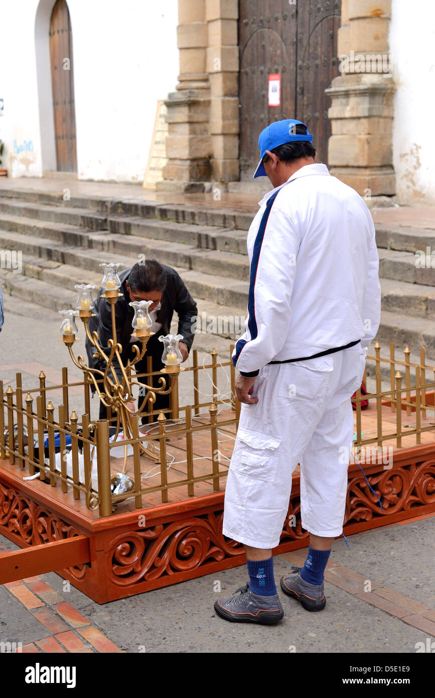 Men preparing one of the wooden symbolic structures to be taken in procession for Easter. Tunja, Boyacá, Colombia, South America Stock Photo