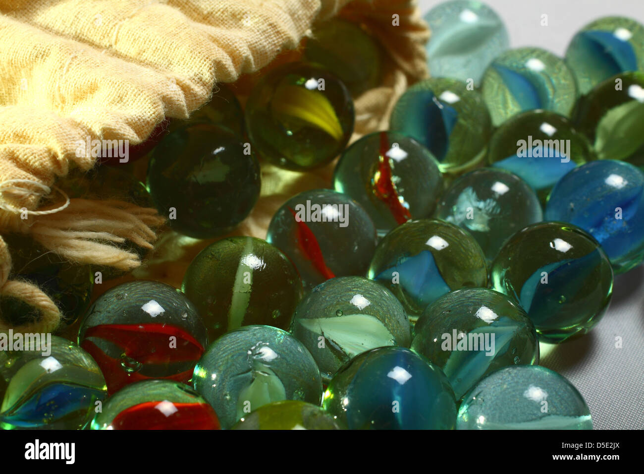 Marbles spilling out of drawstring bag Stock Photo - Alamy