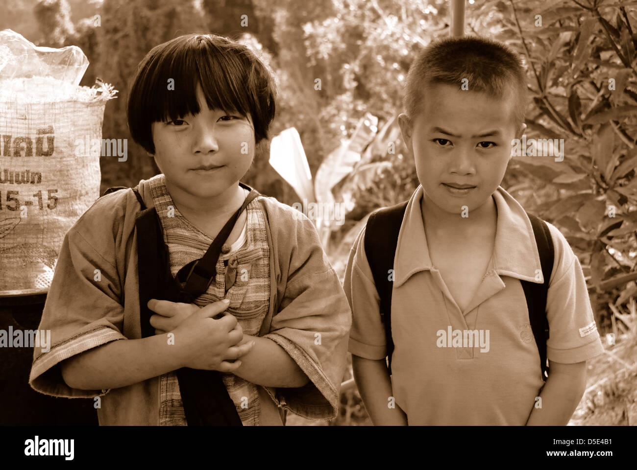 Two children on their way home from school from the bury toey village Chiang mai northern Thailand taken on 01/07/2009 Stock Photo