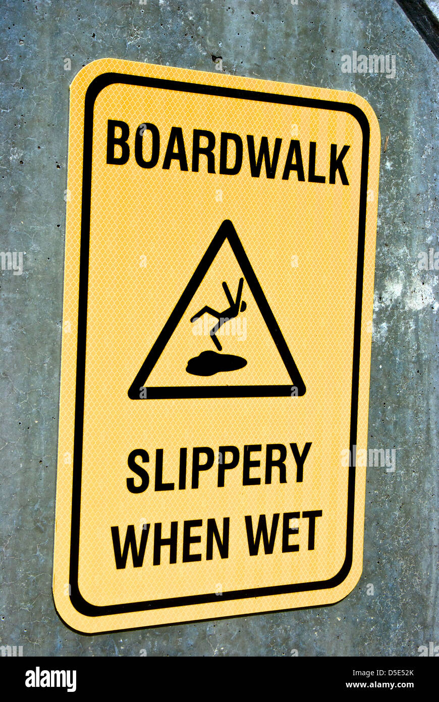 Boardwalk slippery when wet warning sign Stock Photo Alamy