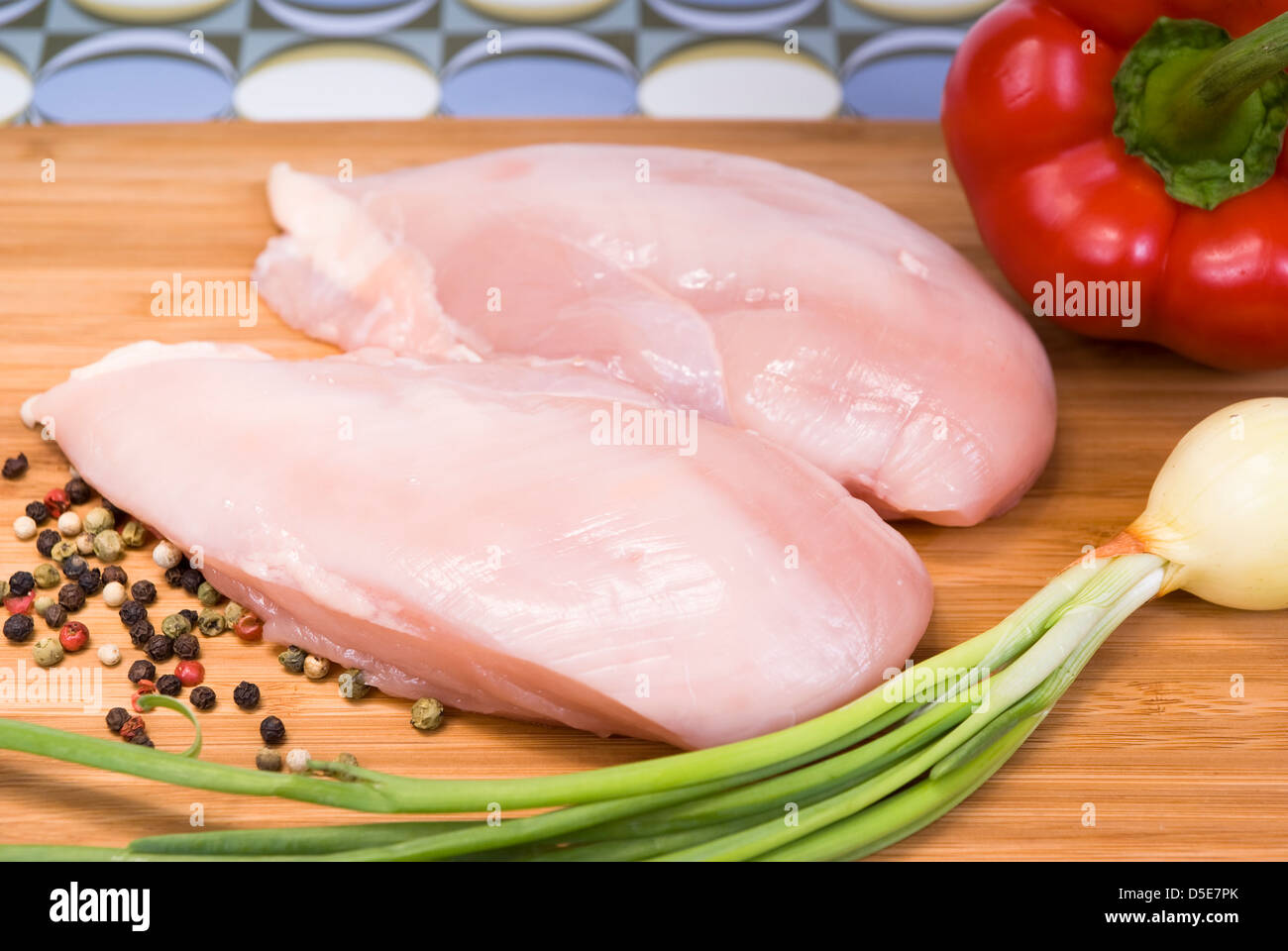 raw portions made with chicken and vegetables Stock Photo