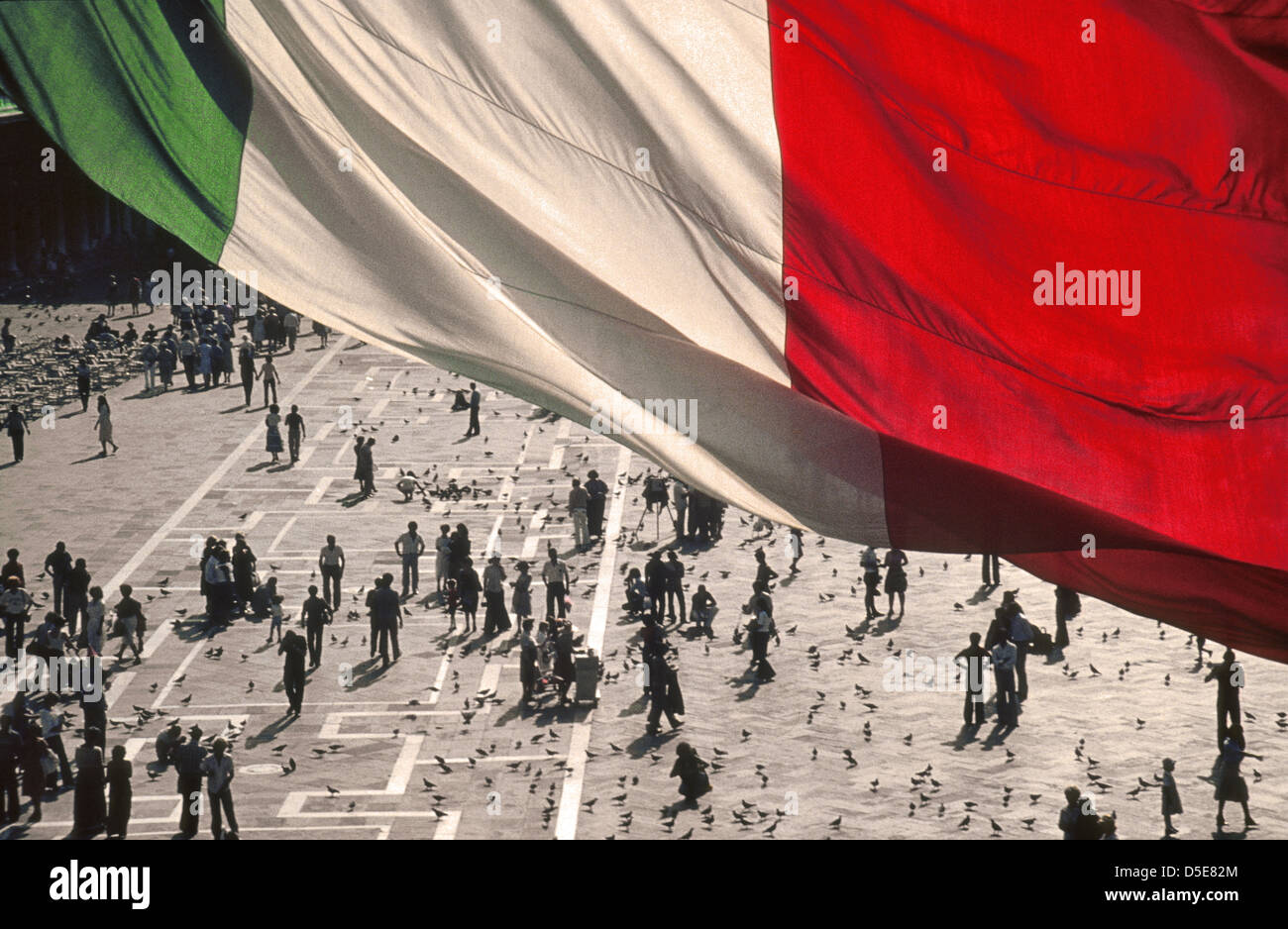 Italian flag in front of St Mark's Basilica, St Mark's Square, Venice, Italy Stock Photo