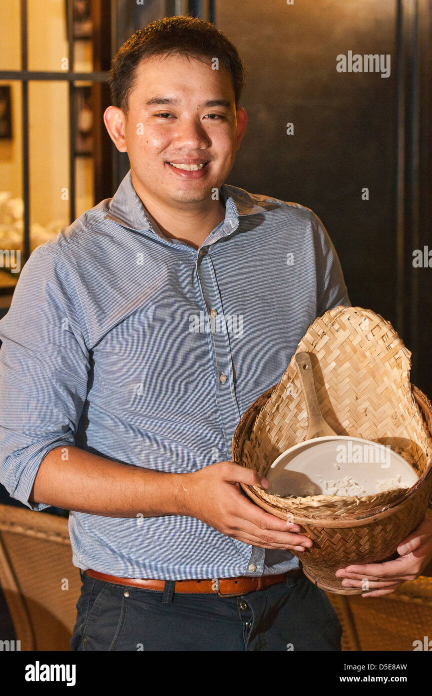 Thai restaurateur and his sticky rice basket Stock Photo