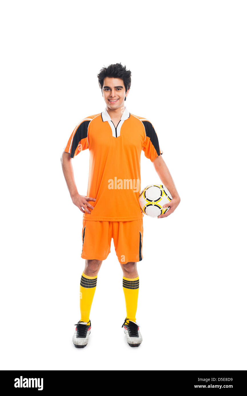 Portrait of a soccer player holding a soccer ball and smiling Stock ...