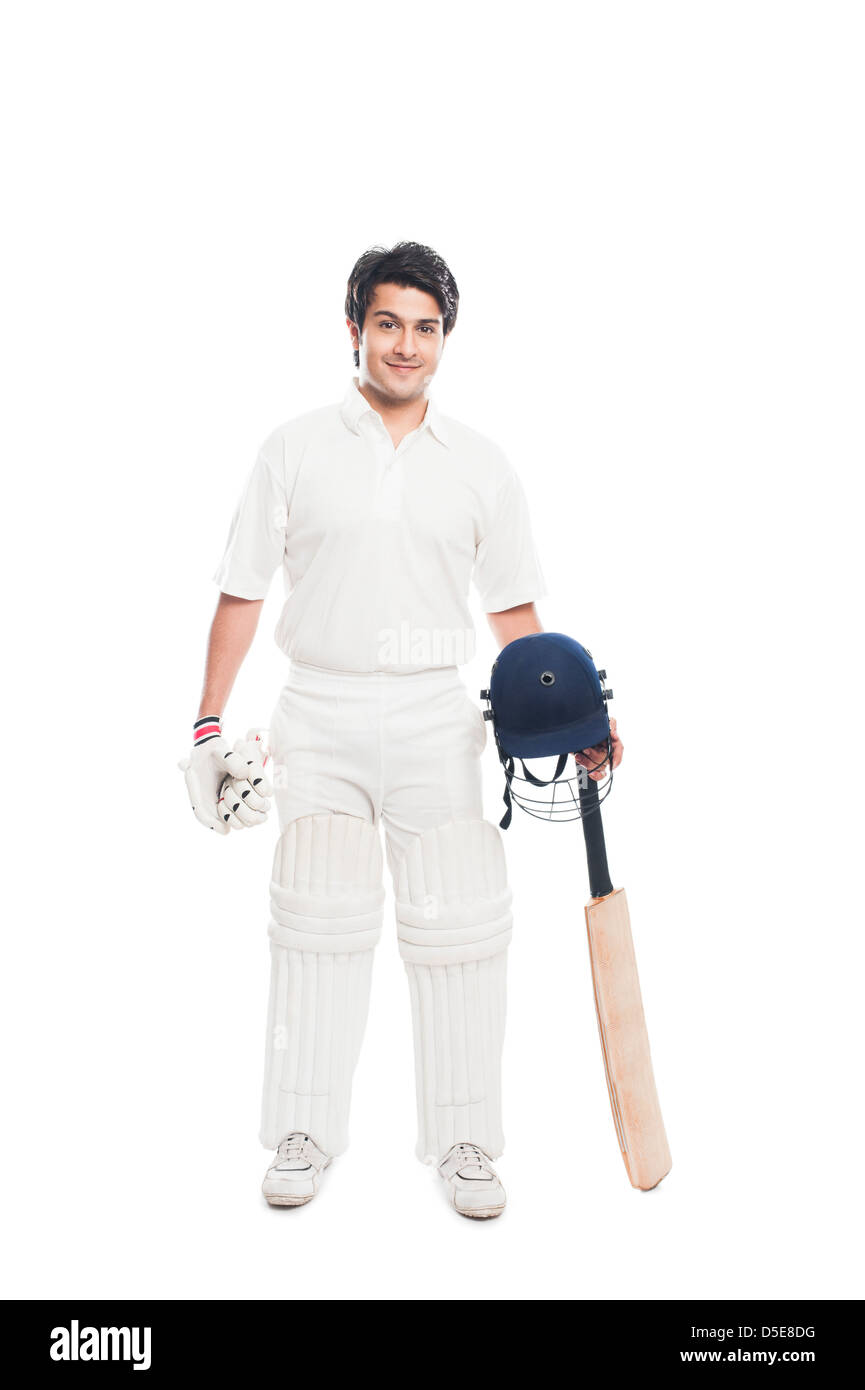 Batsman holding a cricket bat with sports helmet and smiling Stock