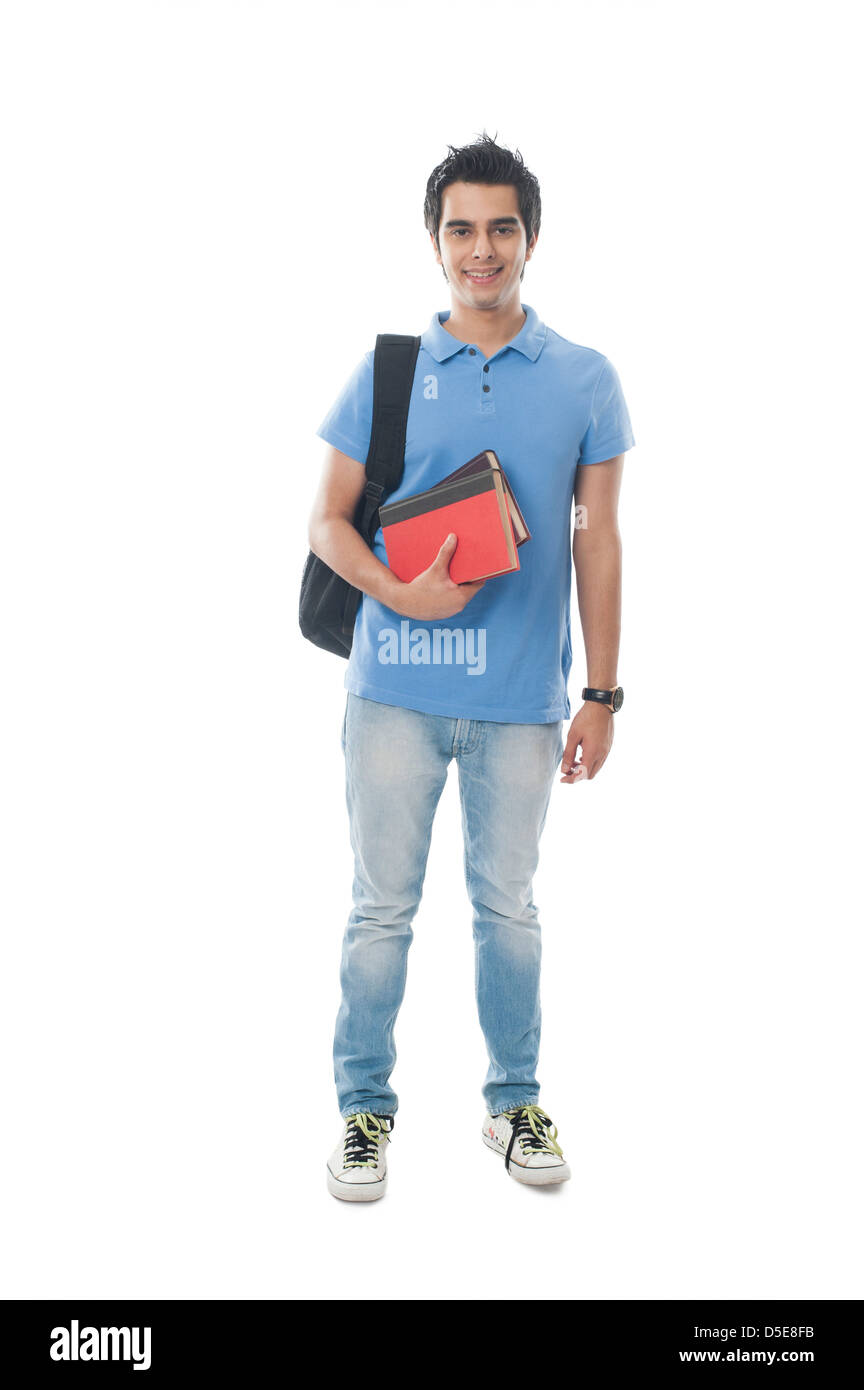 Portrait of an university student holding books and smiling Stock Photo ...