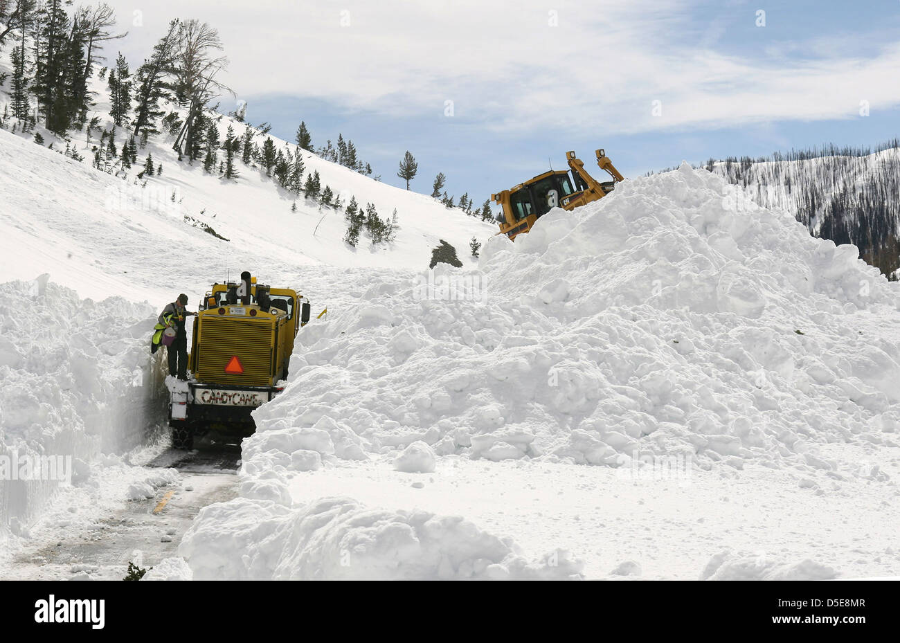 Snow plows clear mountains of snow from the Sylvan Pass in Absaroka Mountain Range Yellowstone National Park April 14, 2008 in Wyoming. Stock Photo