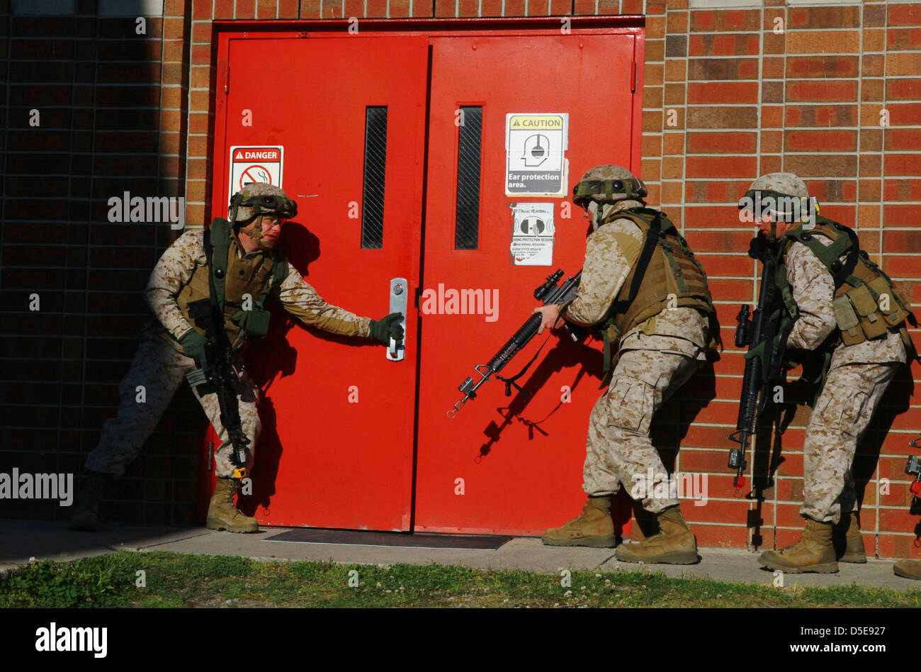 US Marines prepare to breach a door during a training exercise March 27, 2013 at Camp Lejeune, NC. Stock Photo