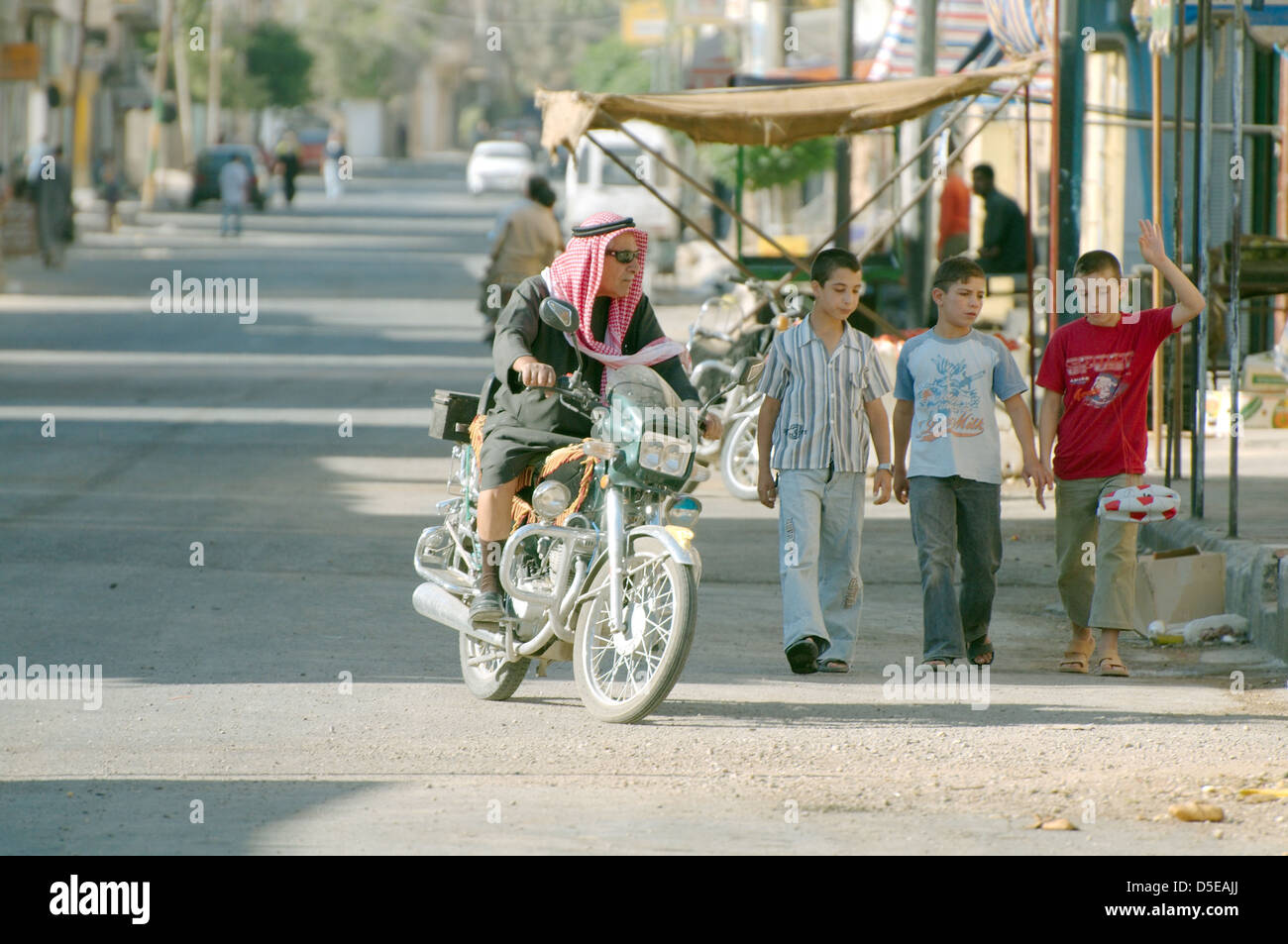 motorcyclist riding down the street, Palmyra, Syria  Stock Photo