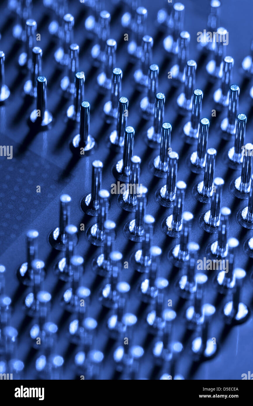 closeup of computer processor pins or computer technology blue background Stock Photo