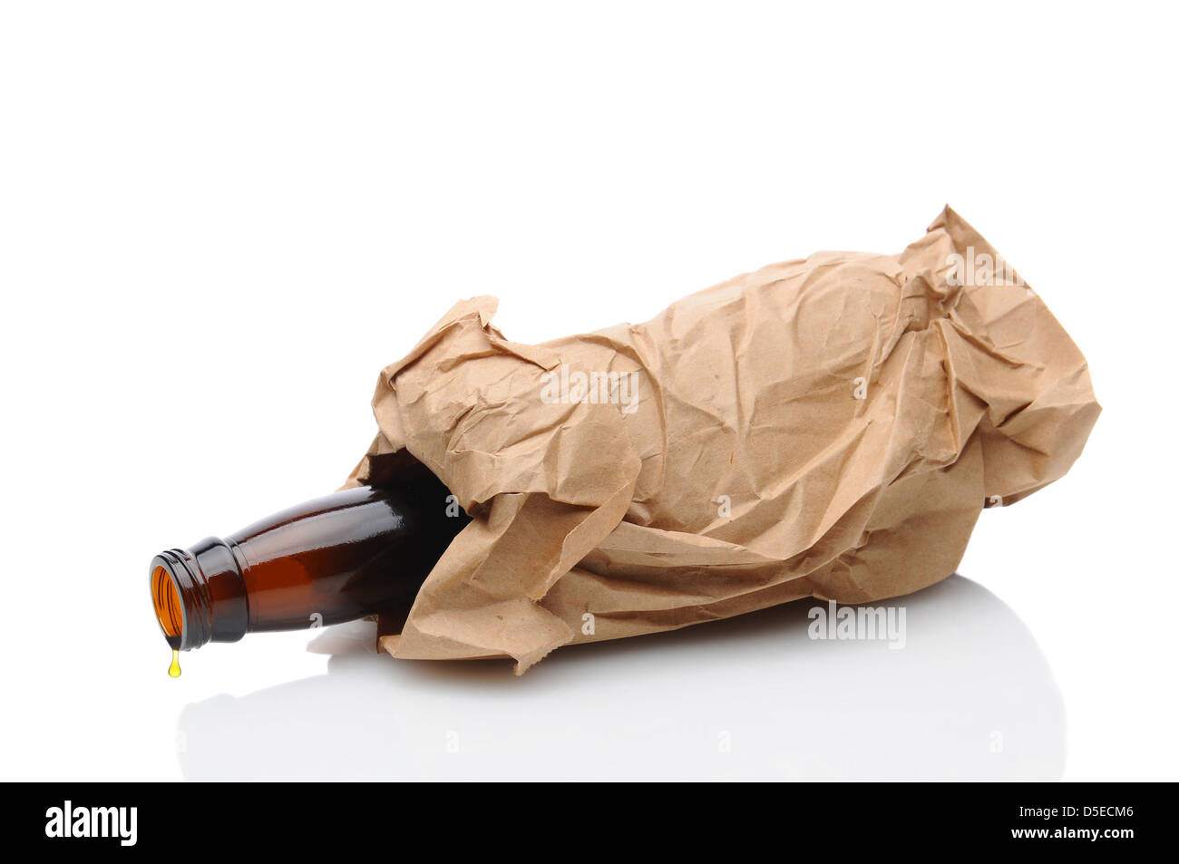 Closeup of a beer bottle inside a brown paper bag laying on its side with a drip on the lip of the container. Stock Photo