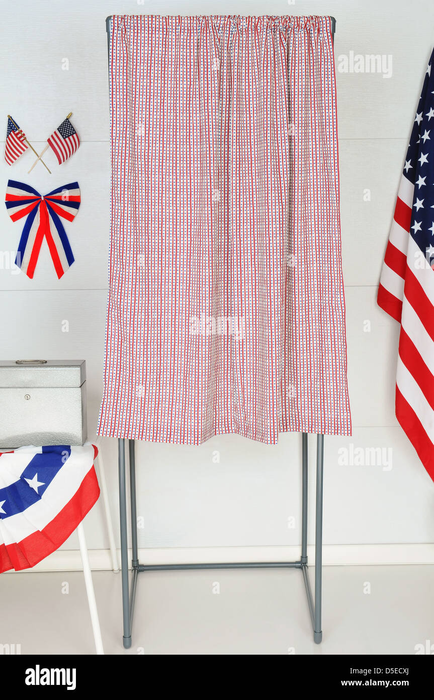 A single voting booth with American flags and bunting with a table and ballot box. Stock Photo