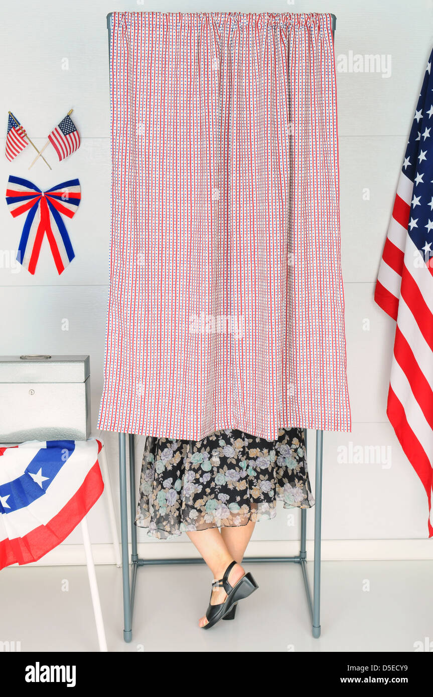 A woman voter inside a Voting Booth at his local polling place. Stock Photo