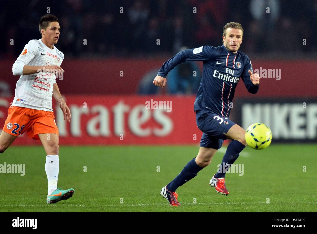 29.01.2013. Paris, France.   David Beckham PSG chased by Jonas Martin MON French League one football. Paris St Germain versus Monpellier. Stock Photo