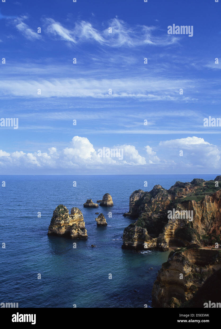 Ponta da Piedade rock formations near Lagos with unusual corkscrew clouds above cirrus and cumulus formations Algarve Portugal Stock Photo