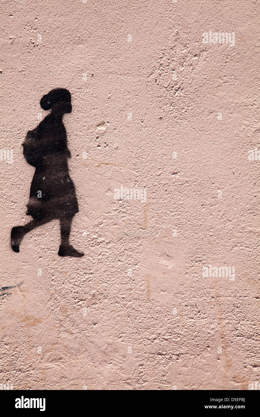 Stencil Graffiti of School Child with satchel Stock Photo