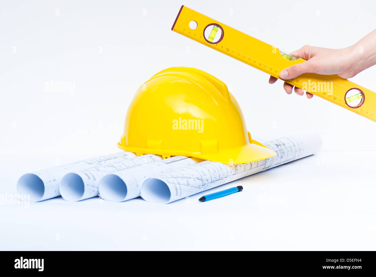 Construction rolls and plans and yellow helmet Stock Photo - Alamy