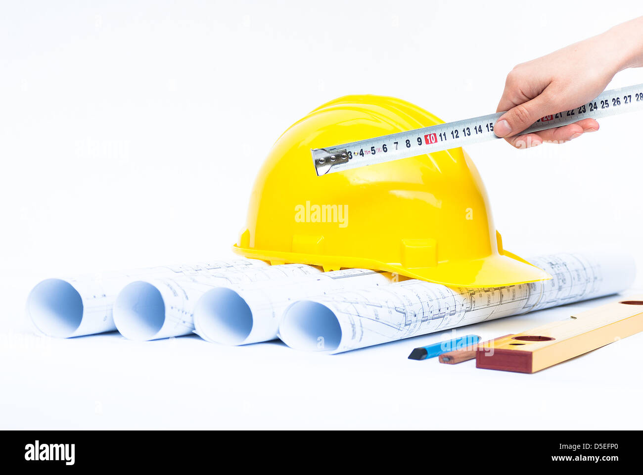Construction rolls and plans and yellow helmet Stock Photo - Alamy