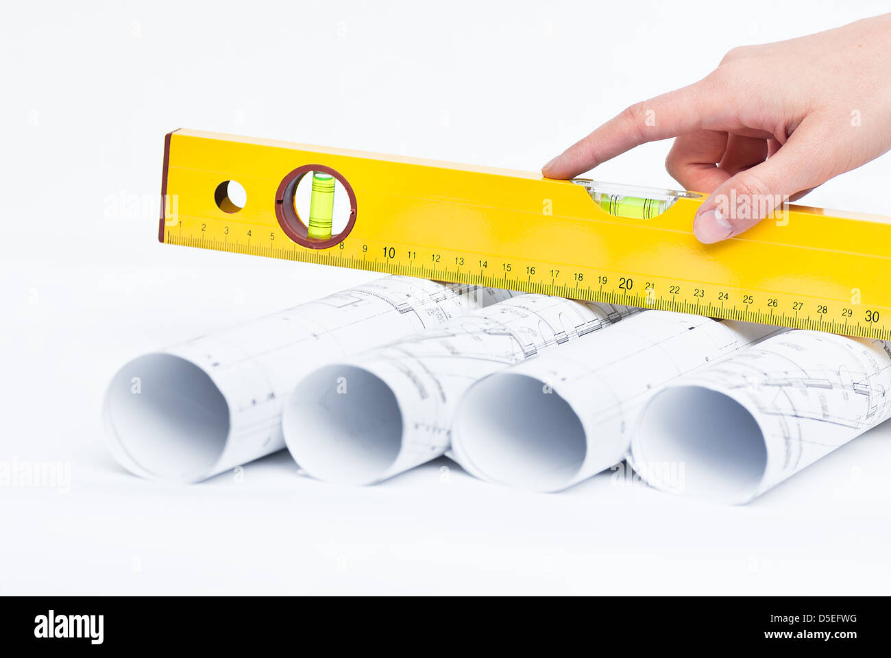 Construction rolls and plans and yellow helmet Stock Photo - Alamy