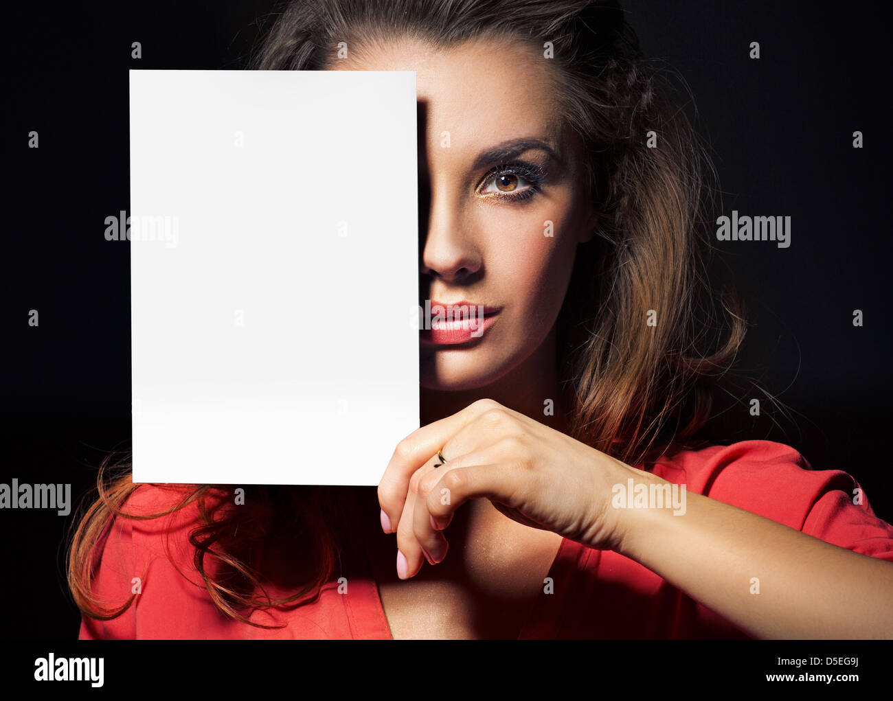 Beautiful woman holding an empty white sheet Stock Photo