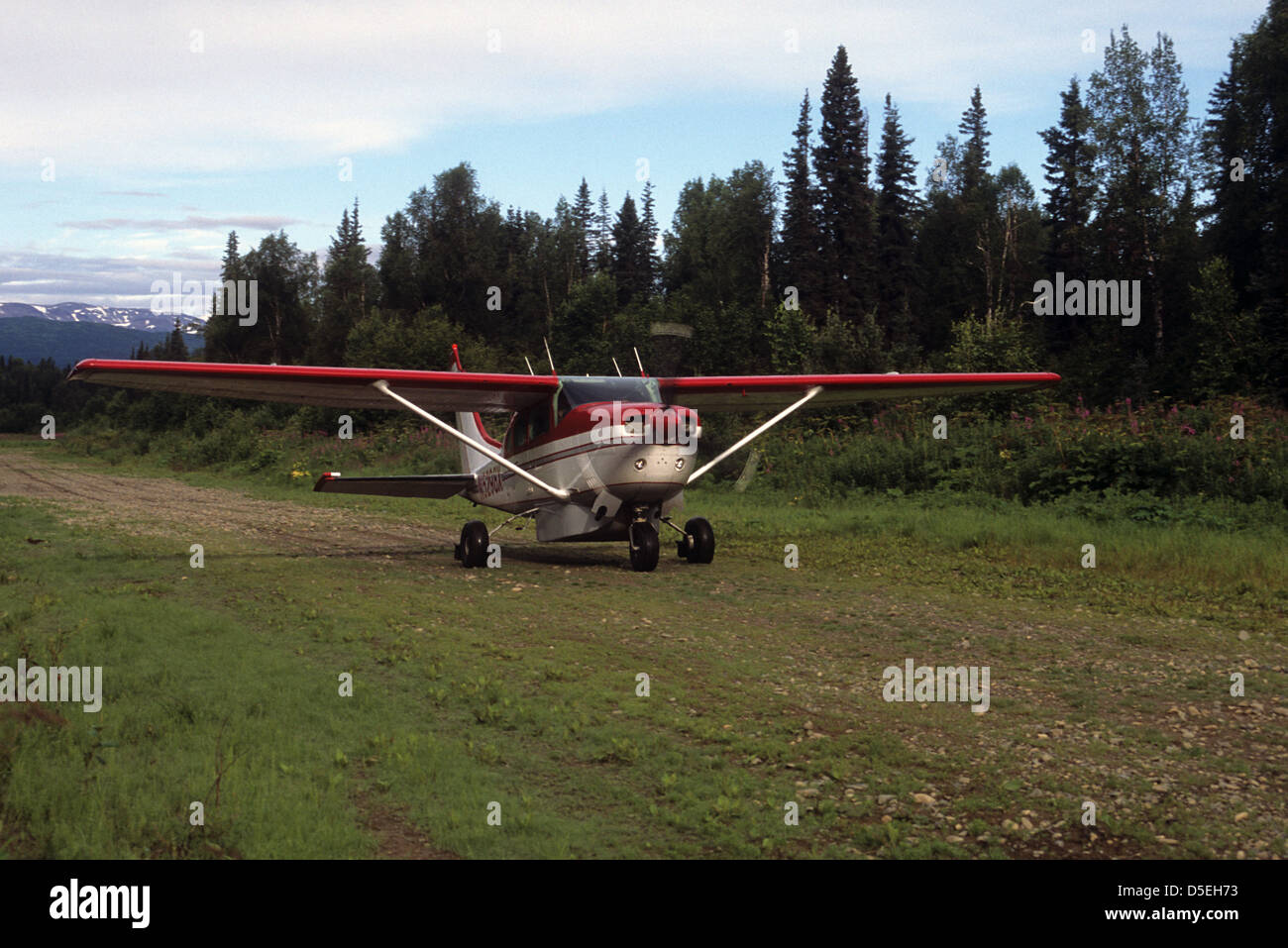 Airplane preparing to take off from a dirt airstrip near the Talachulitna River Alaska Stock Photo