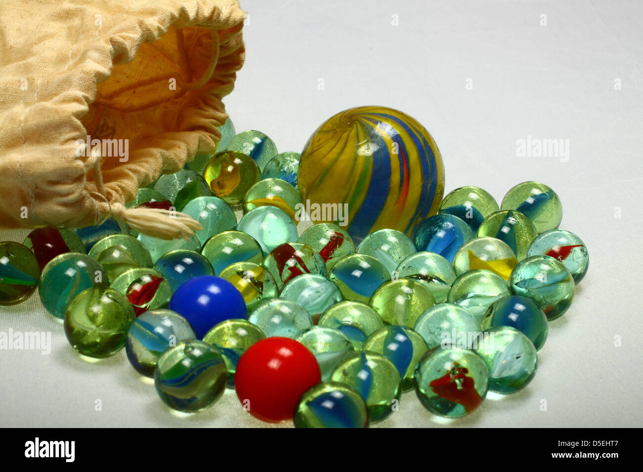Marbles spilling out of drawstring bag Stock Photo Alamy