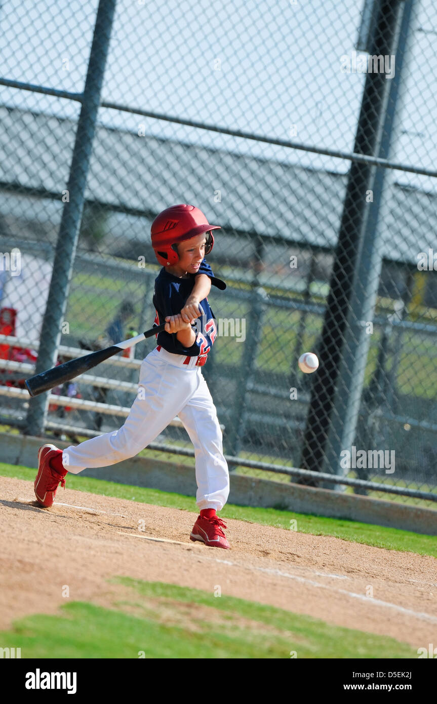 Youth baseball boy swinging the bat Stock Photo Alamy