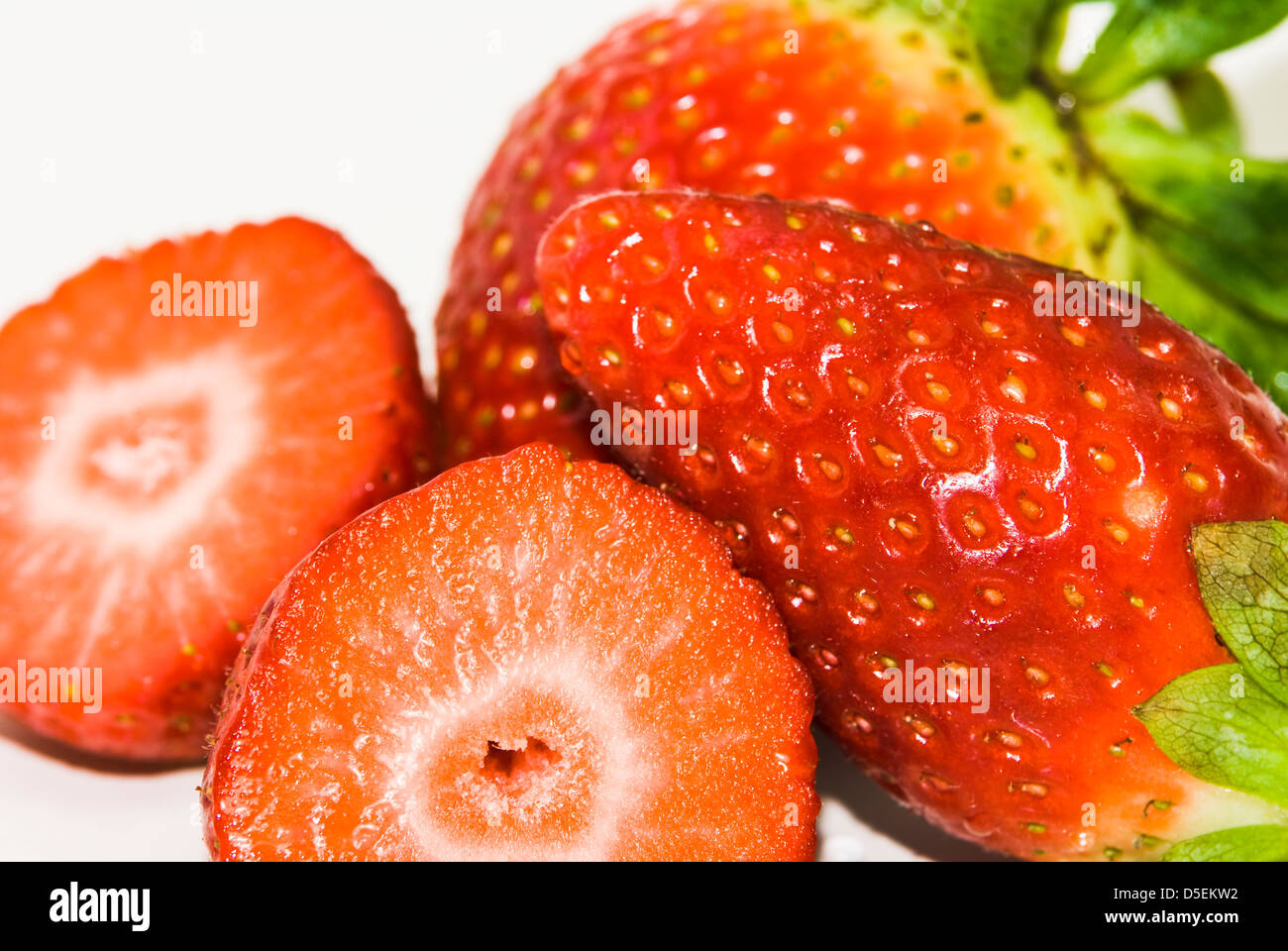 ripe red strawberries with green leaves on white background Stock Photo ...