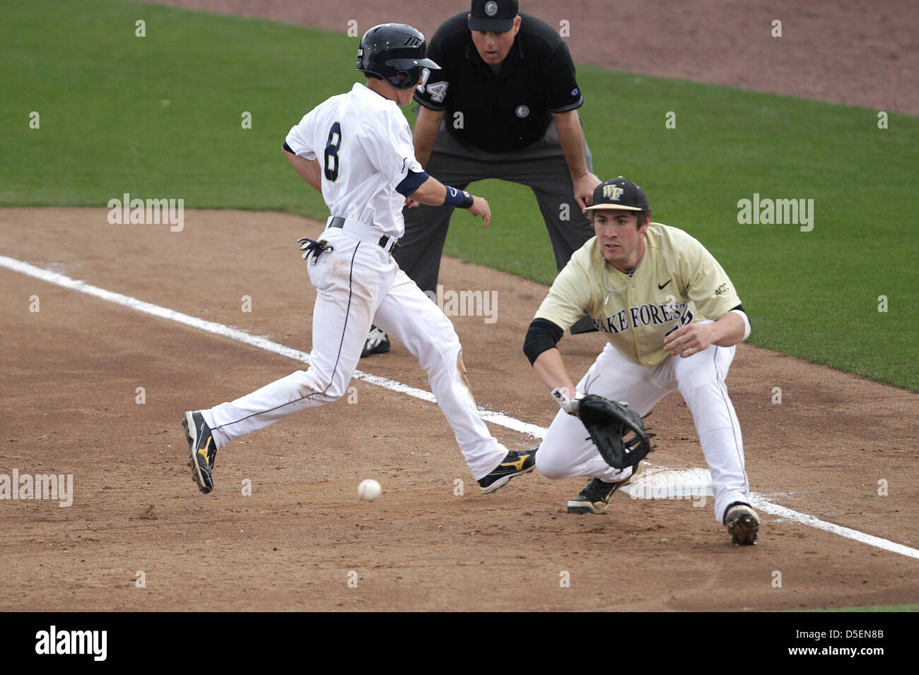 Atlanta, Georgia, USA. 30th March, 2013. The Georgia Tech Yellow Jackets wrapped up a 3-game series with a double header against the the Wake Forest Demon Deacons at Russ Chandler Stadium in Atlanta Georgia. Kyle Wren (8) beats the throw to Demon Deacon 1st baseman Matt Conway (25). The Yellow Jackets dropped the second game to Wake Forest 8-6. Stock Photo
