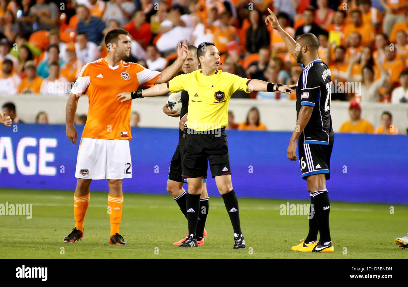 Houston, Texas, USA. 30th March, 2013. Houston Dynamo forward Will Bruin #12 and San Jose Earthquakes defender Victor Bernardez #26 are separated by match referee Jose Carlos Rivero during the MLS regular-season match between the Houston Dynamo and the San Jose Earthquakes from BBVA Compass Stadium in Houston, TX. Houston won, 2-0. Stock Photo