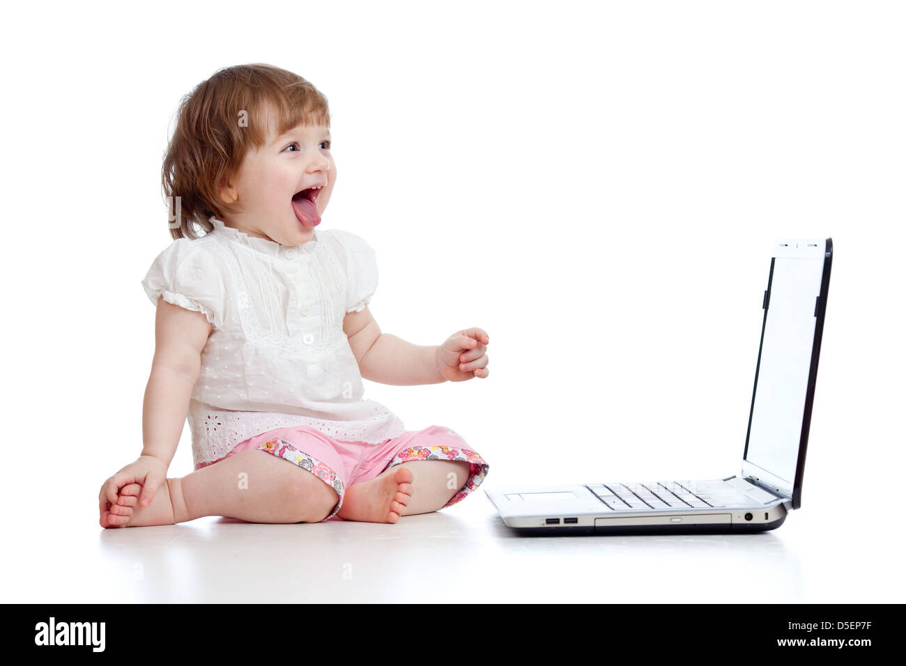 Funny child using a laptop over white background Stock Photo - Alamy