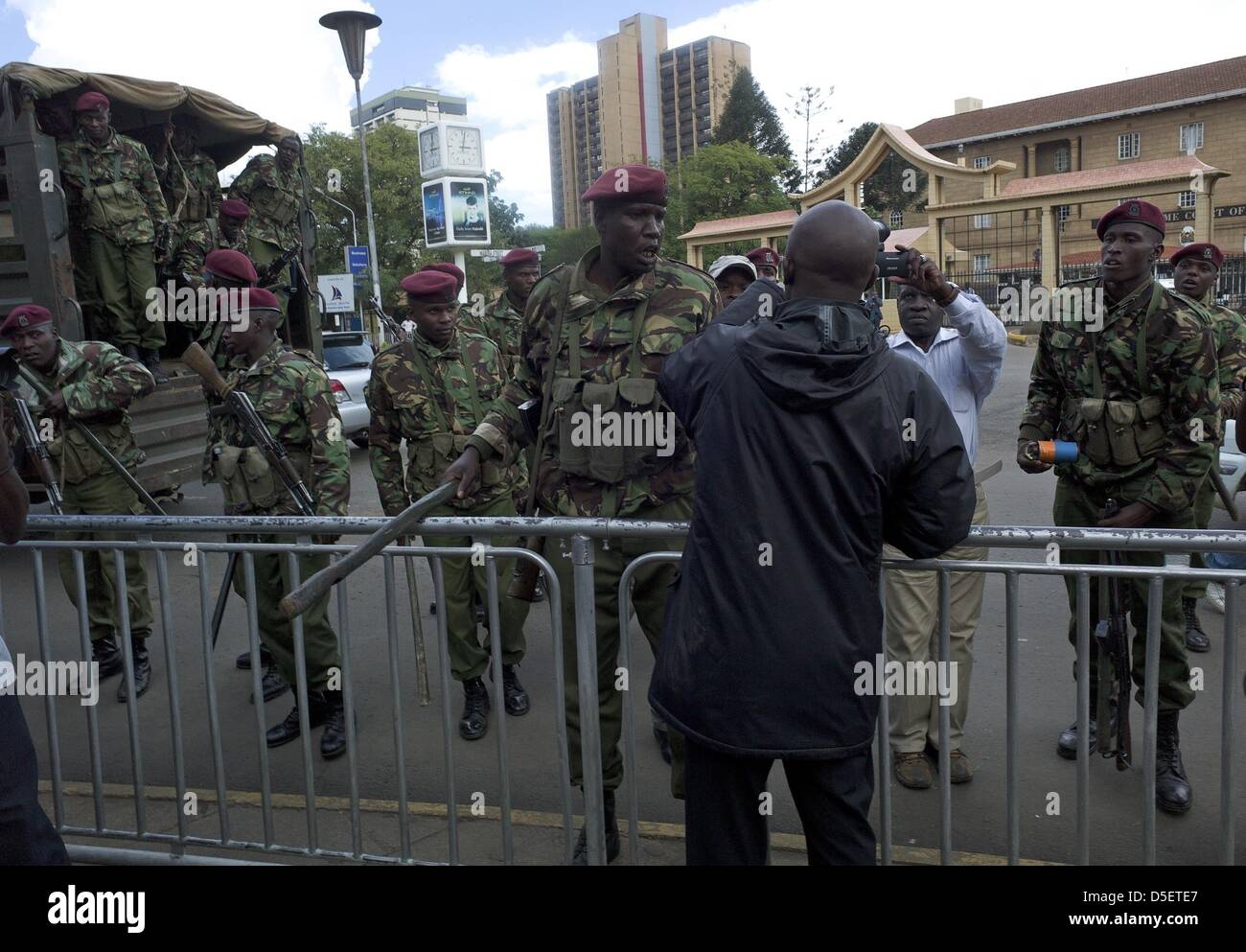 Nairobi, Kenya. 30th March, 2013. Officers with the Kenyan General Service Unit (a special division of the police department) detain a protester outside the grounds of the Supreme Court building. The court upheld Uhuru Kenyatta's presidential poll victory, rejecting challenger Raila Odinga's petition. Presidential, legislative and municipal elections were held on March 4. Mr. Odinga, who polled second, challenged the results; he said the vote was not credible because of failures with the electronic voter ID system and the vote counting mechanism. (Cre Stock Photo