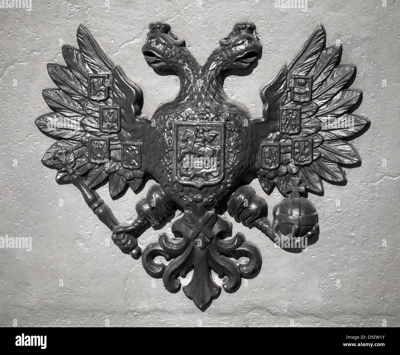 Double Eagle - Emblem of Russia. Ancient black bas-relief on gray vintage wall Stock Photo