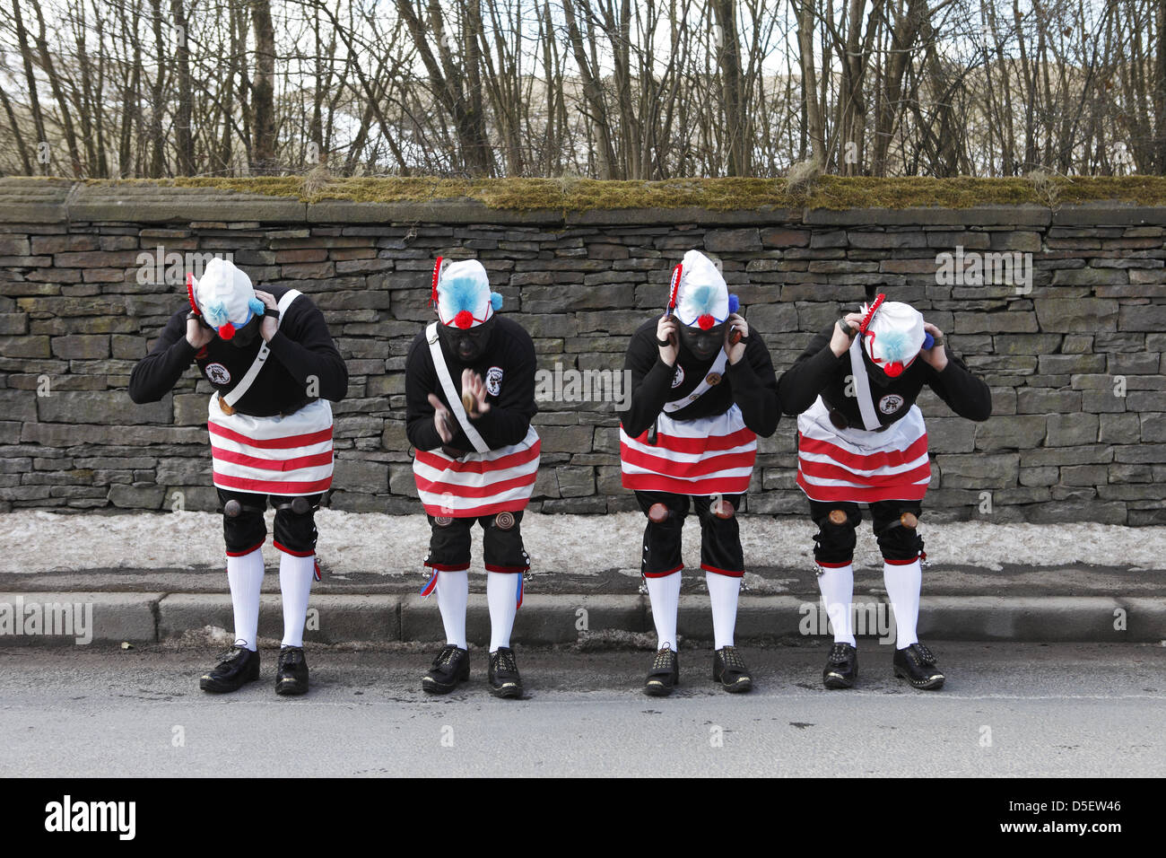 Britannia Coco-nut Dancers of Bacup, accompanied by Stacksteads Silver Band, dance their way around Bacup, UK on Easter Saturday Stock Photo