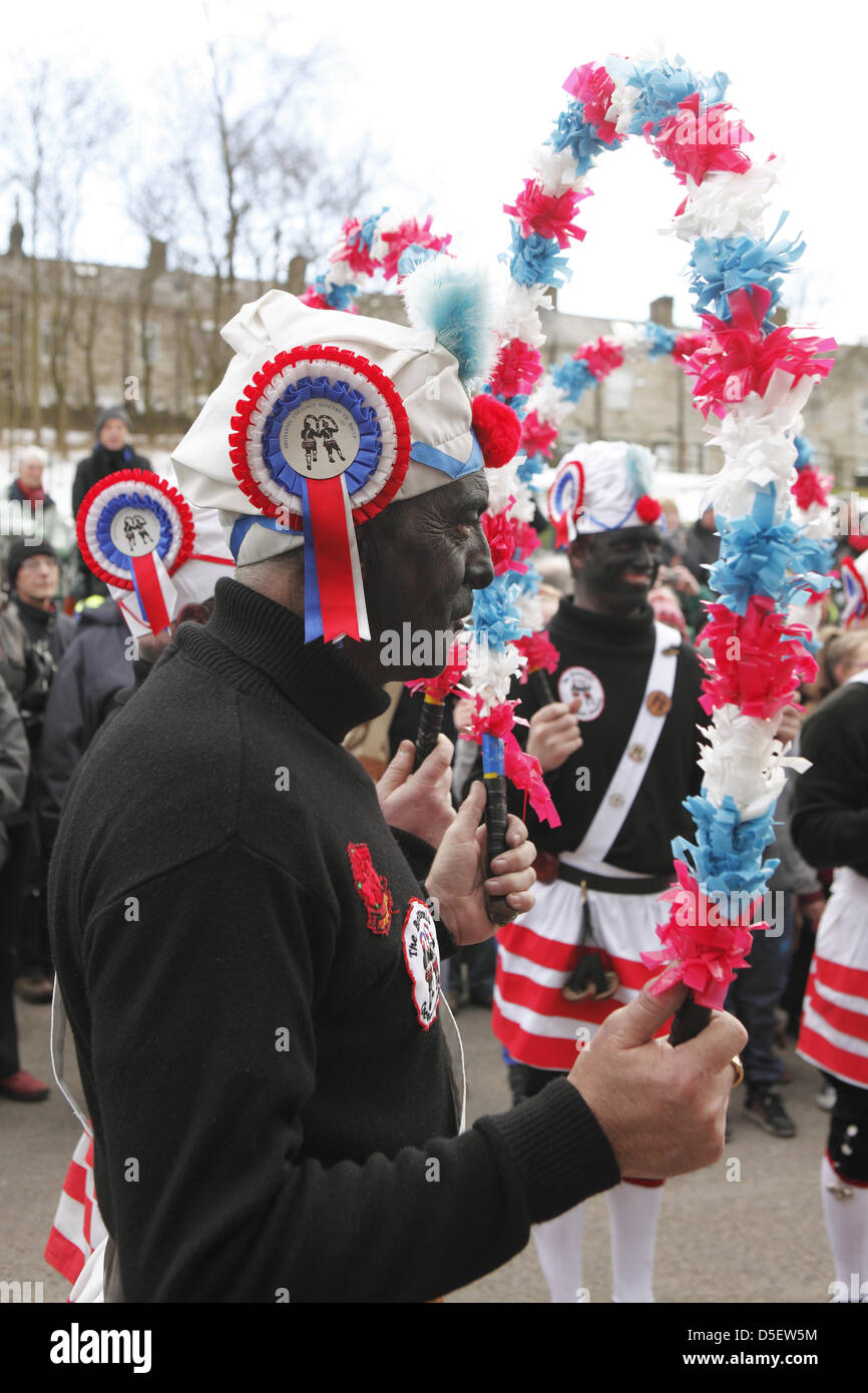 Britannia Coco-nut Dancers of Bacup, accompanied by Stacksteads Silver Band, dance their way around Bacup, UK on Easter Saturday Stock Photo